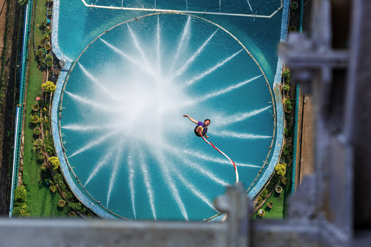 Person doing a splash bungee jump into the water