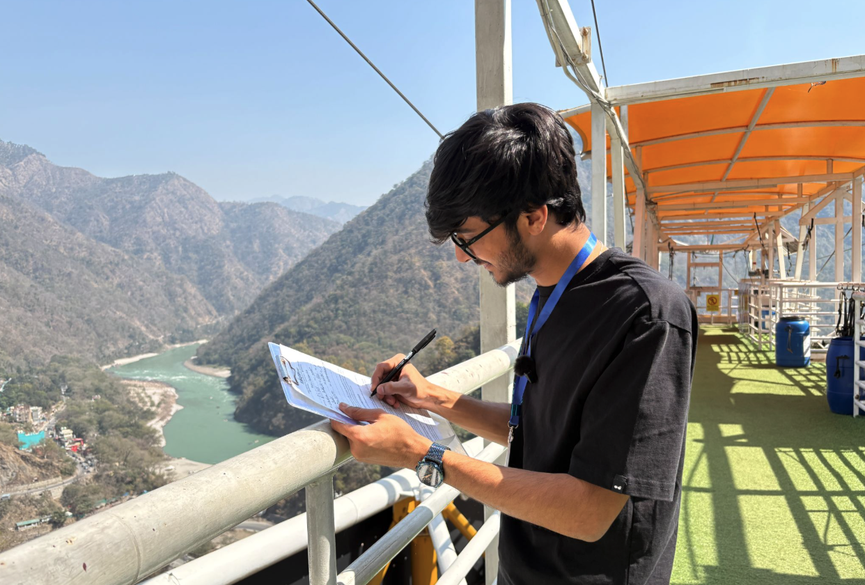 Bungee jumping crew member with a registration form