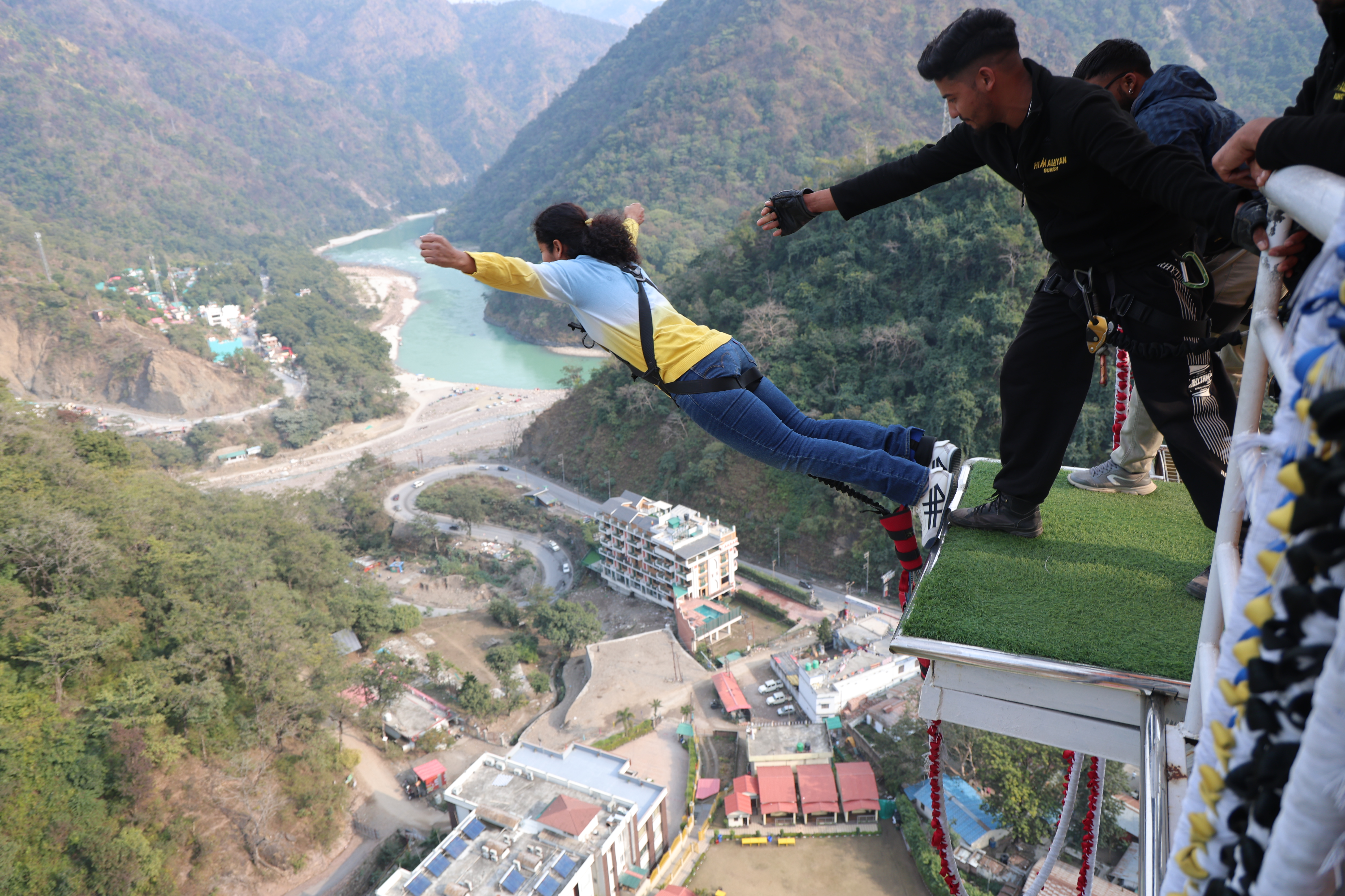 Bungee jumping in Rishikesh from a high platform over the river