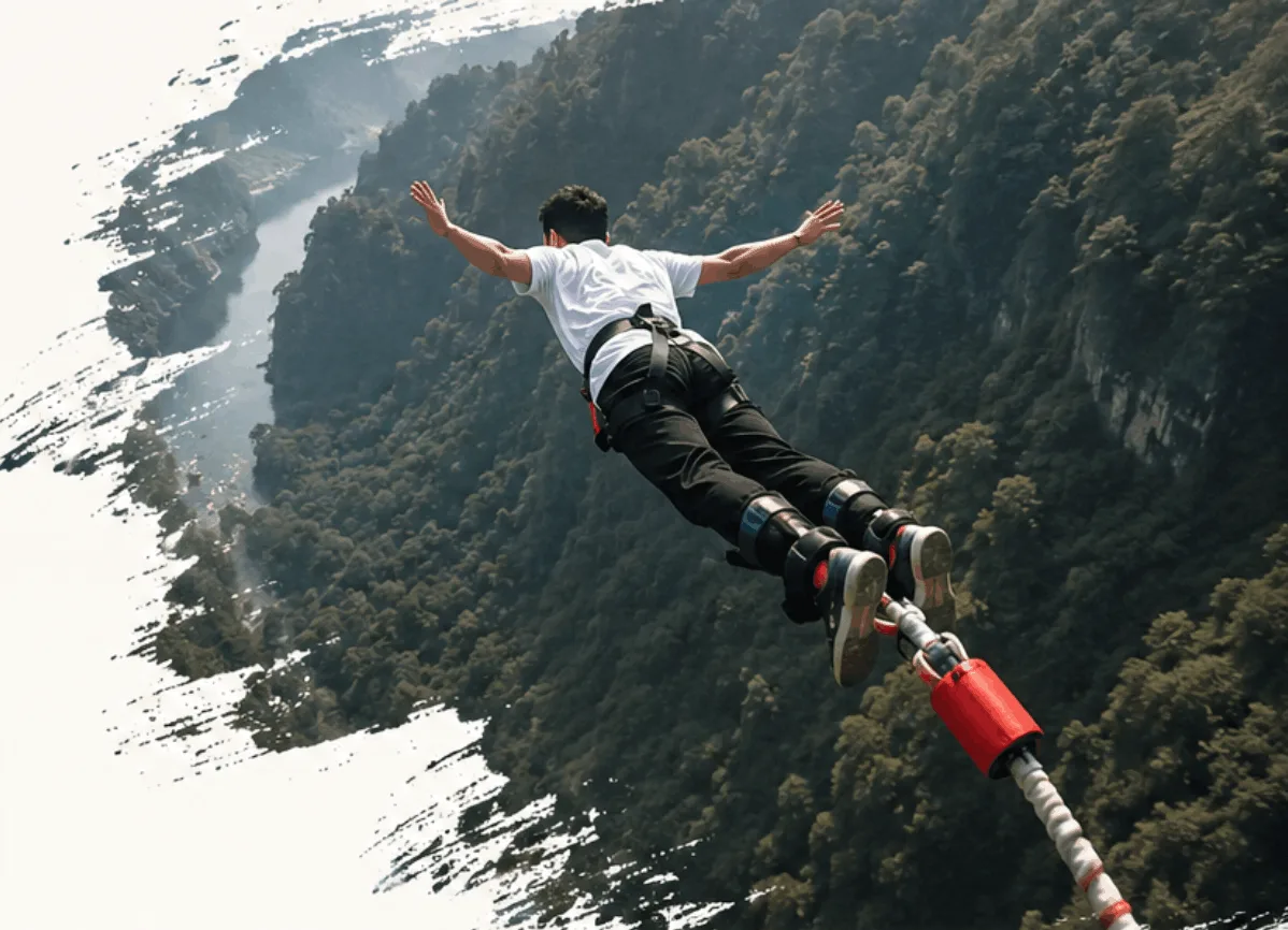 Person bungee jumping from a cliff with a river valley in the background